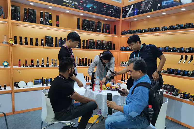 Buyers handling flashlights at the PLD LED China Import and Export Fair (Canton Fair) 2026 booth